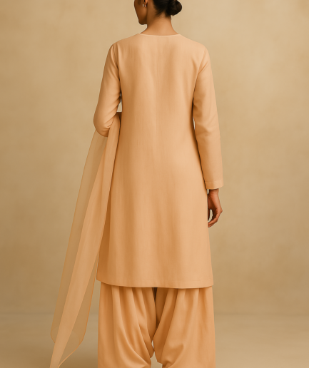Model wearing a dusty rose Farshi Shalwar Kameez with long kameez and wide shalwar from the Rang e Seher collection by Hannah Syed. back pose